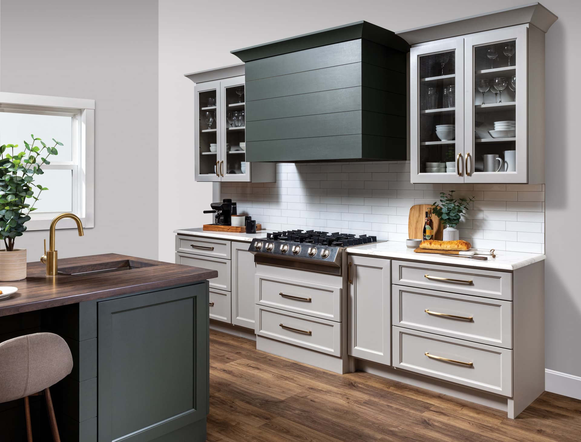 Modern kitchen with green range hood and gold hardware