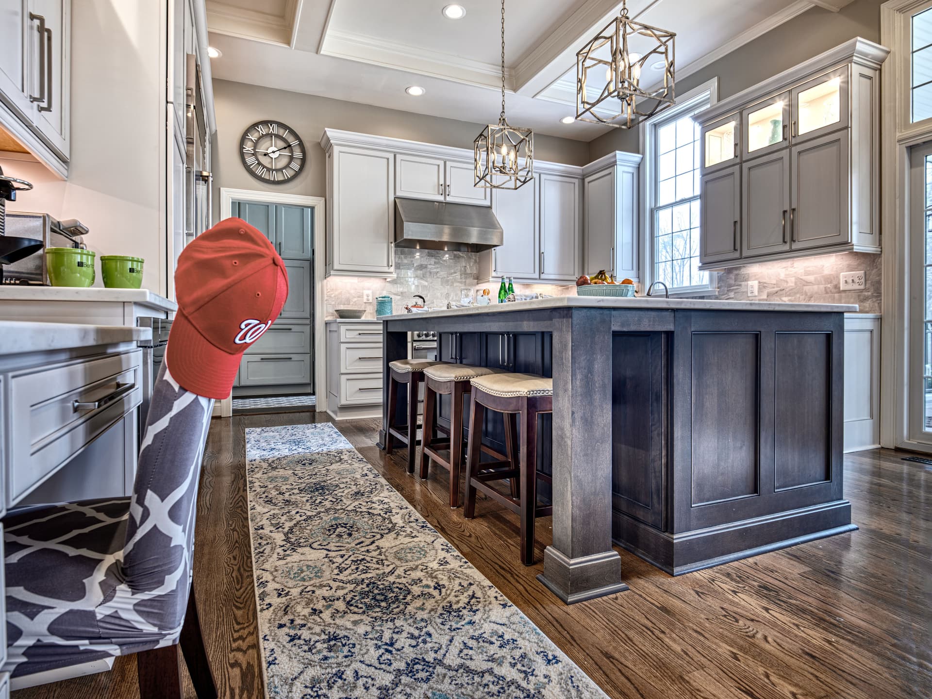 Spacious traditional kitchen with coffered ceiling and dark island